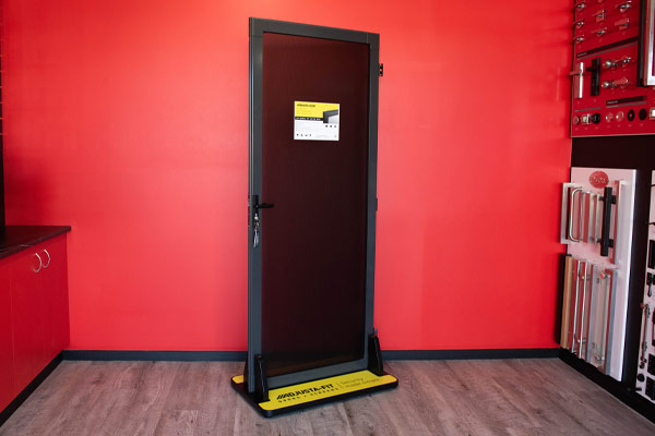 Black security door on display with red background