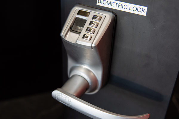 Silver door handle and keypad lock on a black door